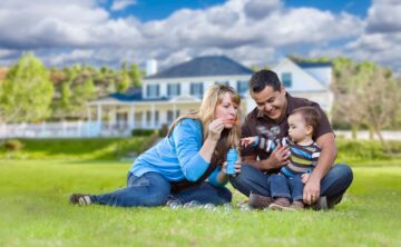 Family blowing bubbles on the lawn