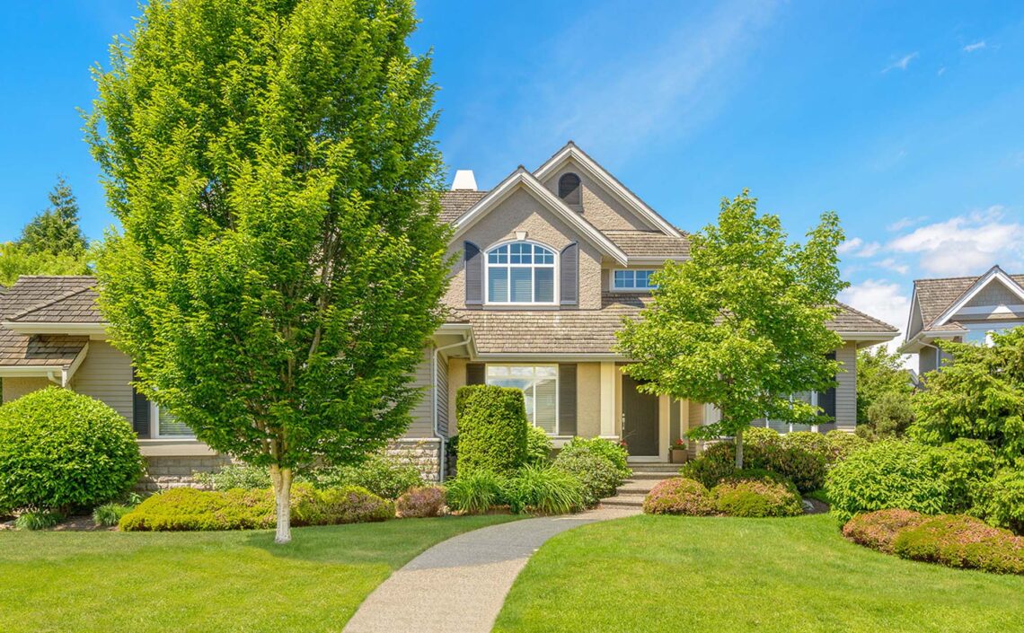 Tan suburban house with nice landscaping